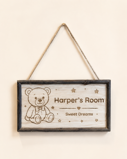 Personalized framed wooden nursery name sign hanging by jute rope