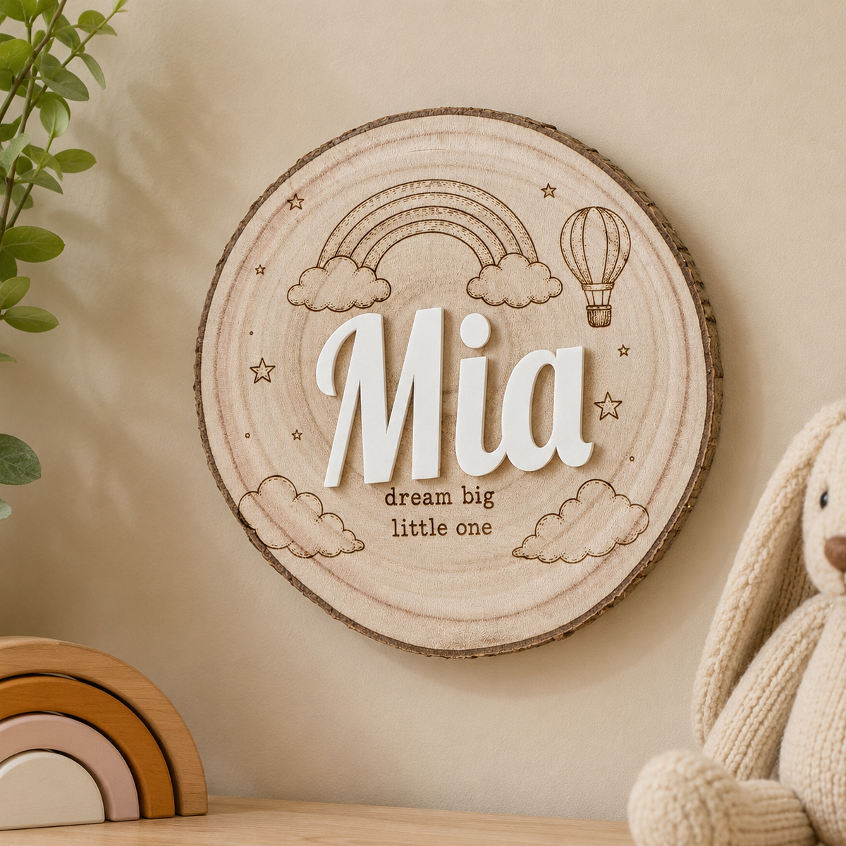 Personalized wooden nursery name sign with raised acrylic letters and engraved line art