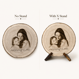 Side view of a natural wood slice with mother and child engraved portrait and visible bark edge.